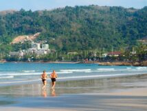 Healthy mature couple running beach