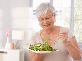 older woman eating vegetables